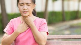 Woman has sore throat in the garden