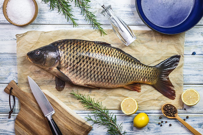 Cooking fish. Fresh carp and ingredients on white table. Preparing healthy eating. Flat lay