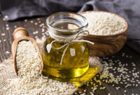 Sesame oil in glass and seeds