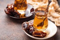 Traditional arabic tea and dry dates. Selective focus